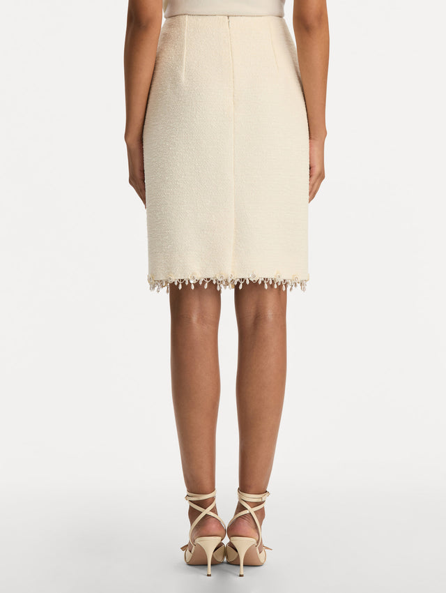 White Floral Jeweled Fringe Tweed Skirt featuring a fitted silhouette with jeweled applique along hem. Back View.