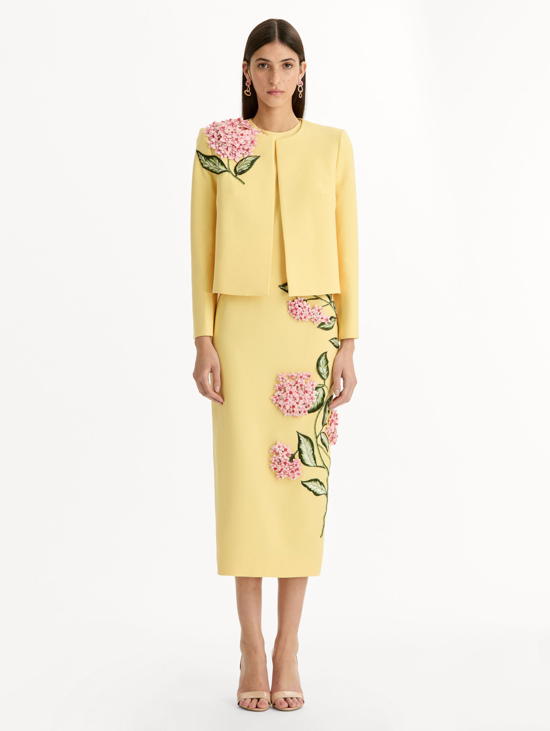 Cropped yellow jacket tailored from double-faced stretch wool and finished with sculptural porcelain flower embroidery at the shoulder. Front View.