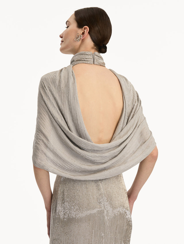 Silver Bugle Bead Lamé Draped Gown with a high neckline, draped cape sleeves, and metallic finish. Zoom View.