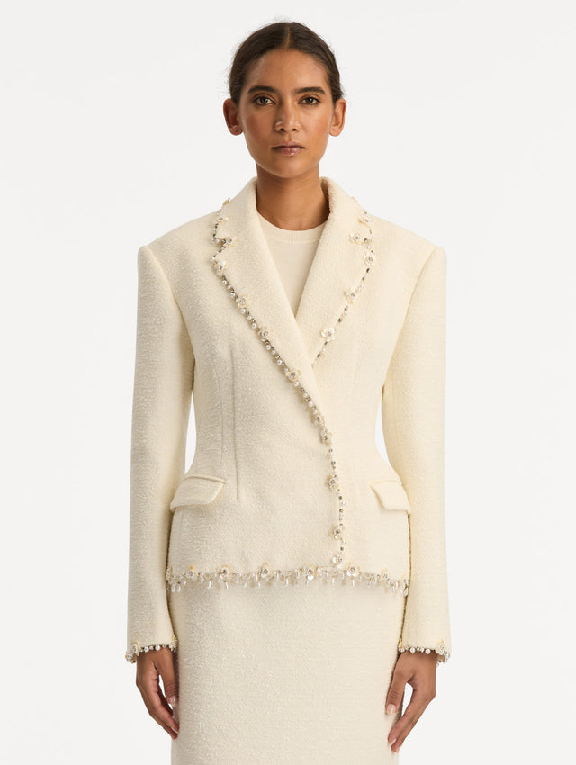 White Floral Jeweled Fringe Tweed Jacket featuring a fitted silhouette with jeweled applique along hems. Front View.