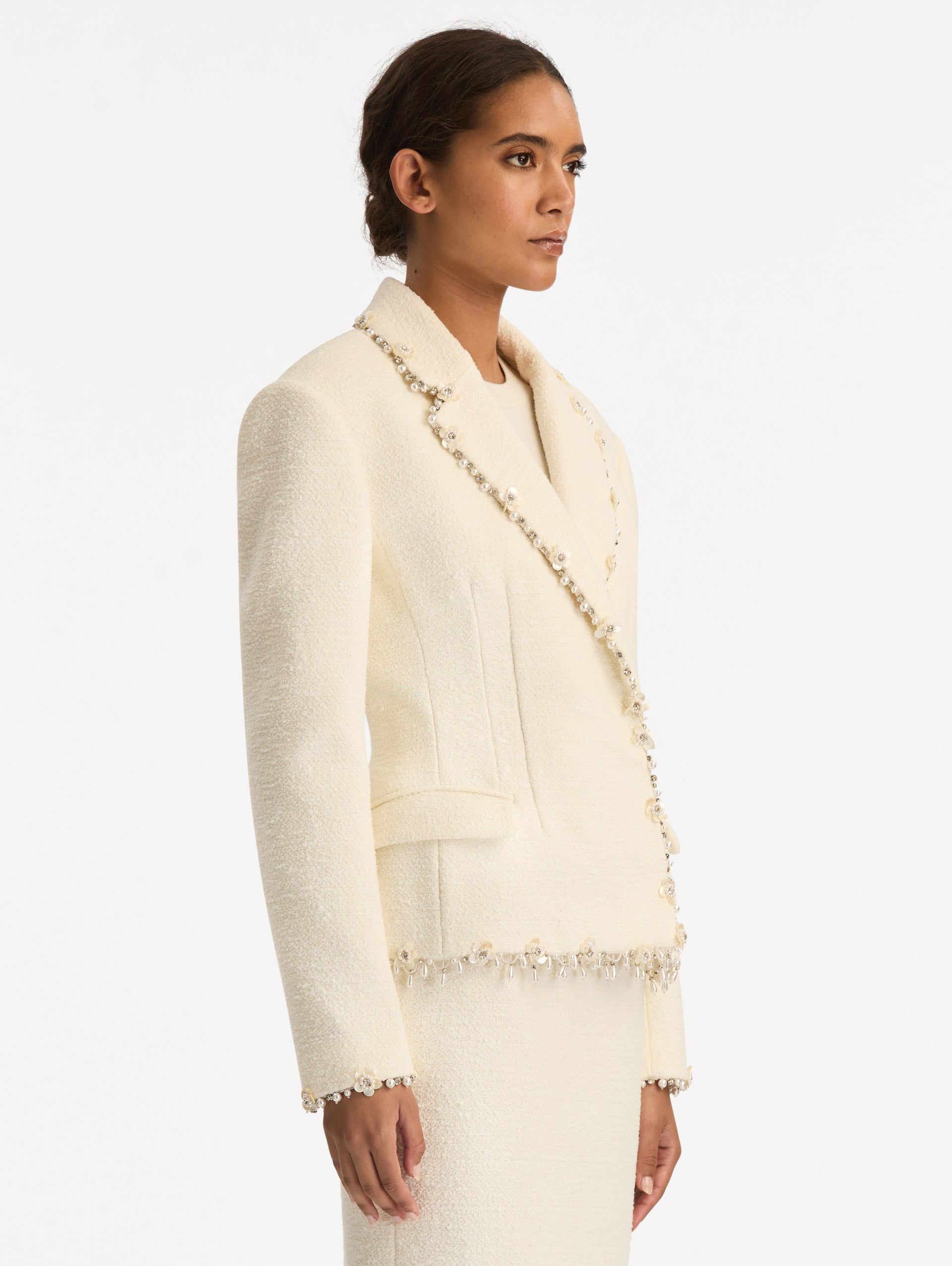 White Floral Jeweled Fringe Tweed Jacket featuring a fitted silhouette with jeweled applique along hems. Side View.