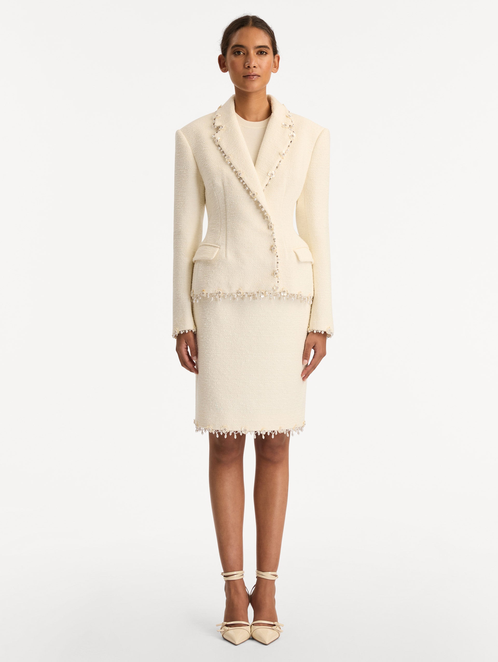 White Floral Jeweled Fringe Tweed Jacket featuring a fitted silhouette with jeweled applique along hems. Front View.