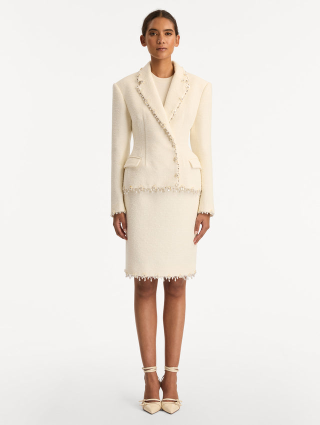 White Floral Jeweled Fringe Tweed Jacket featuring a fitted silhouette with jeweled applique along hems. Front View.