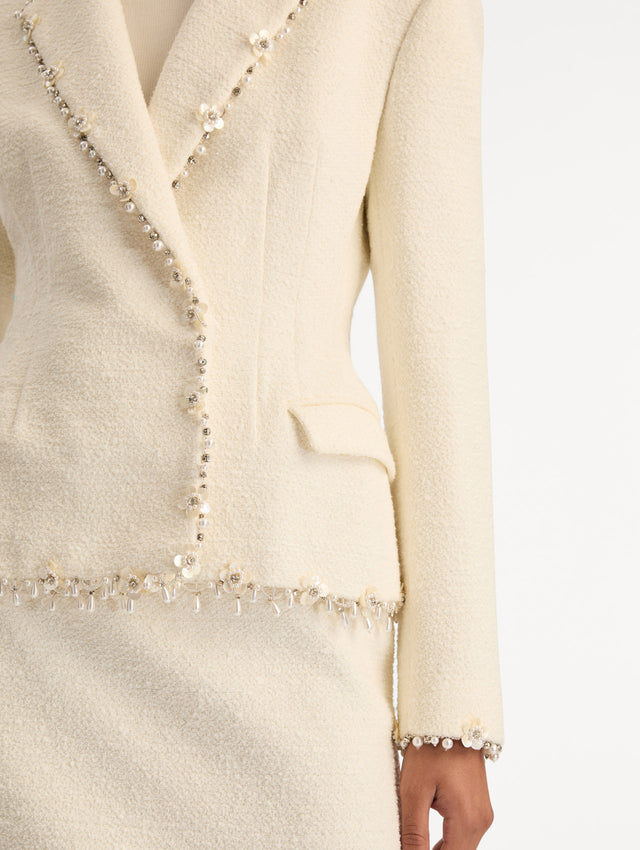White Floral Jeweled Fringe Tweed Jacket featuring a fitted silhouette with jeweled applique along hems. Zoom View.