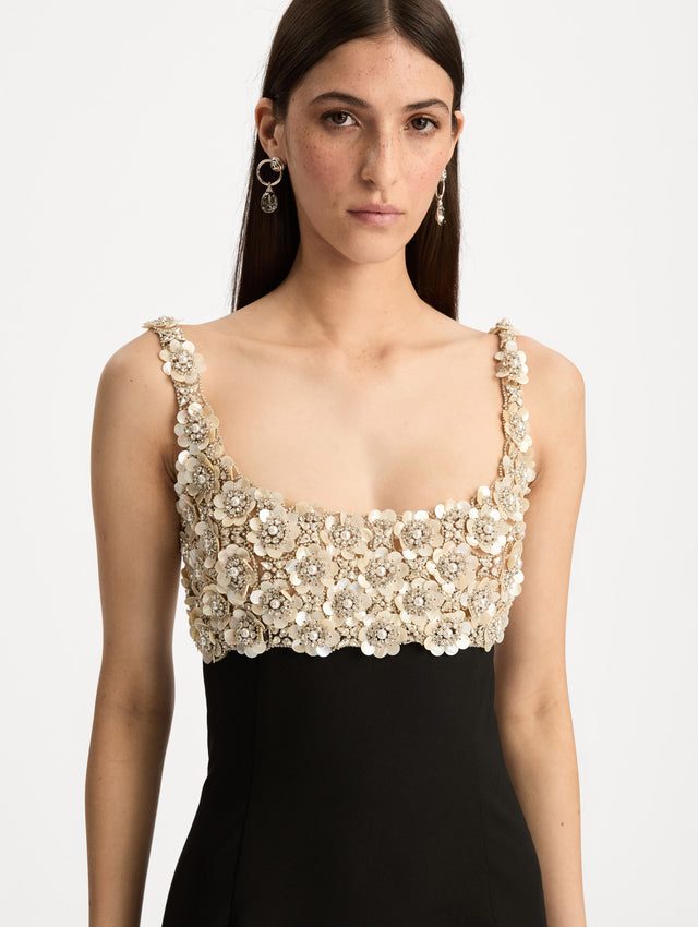 Black Mother of Pearl Embroidered Sleeveless Gown with a form fitting, floor length silhouette and an embellished bodice. Zoom View.