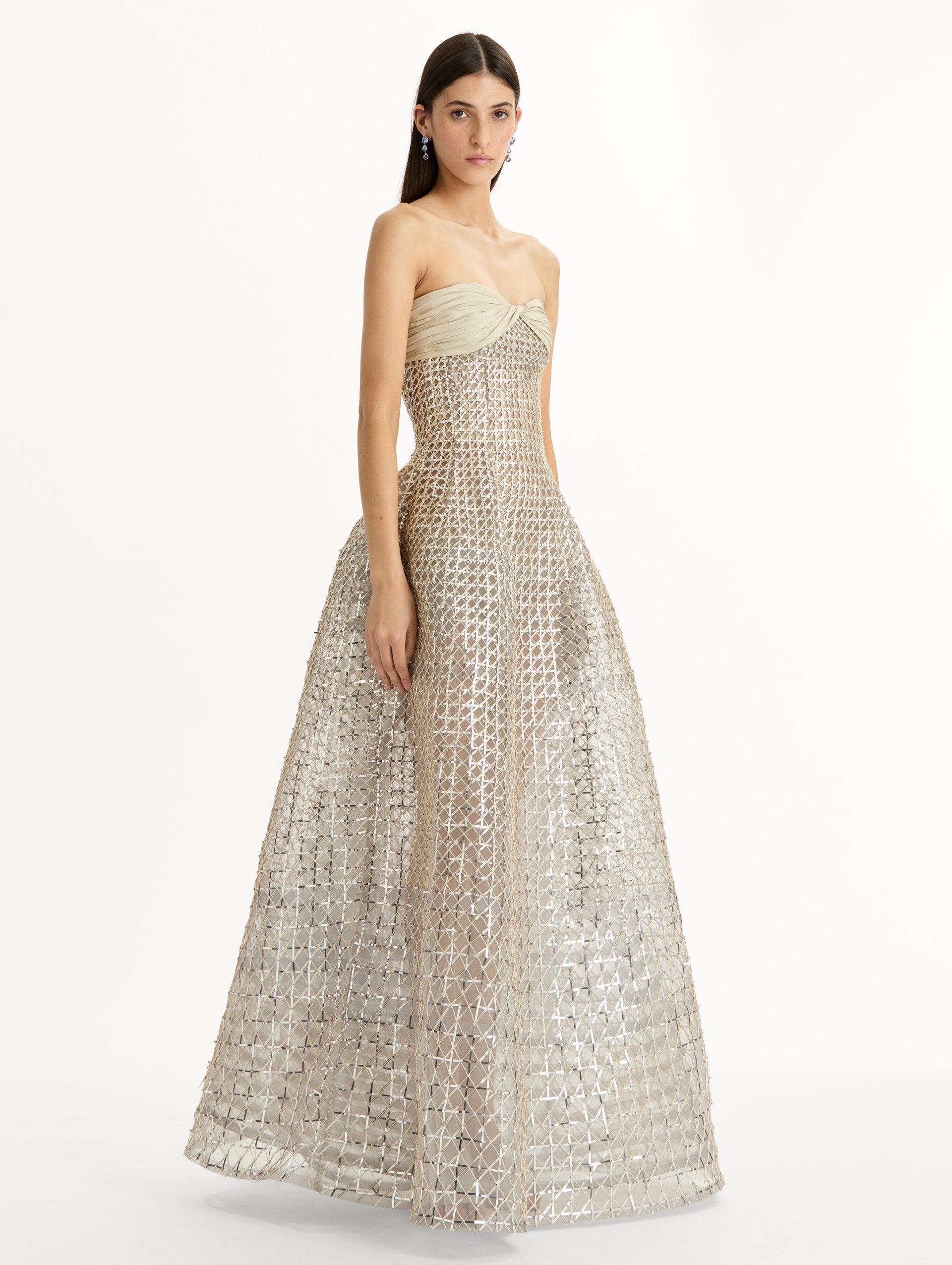 Floor length, silver, strapless Sequin & Bugle Bead Lattice Gown with Sheer Skirt. Side View.