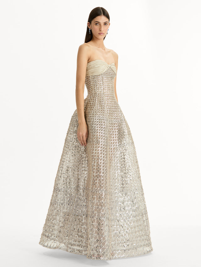 Floor length, silver, strapless Sequin & Bugle Bead Lattice Gown with Sheer Skirt. Side View.