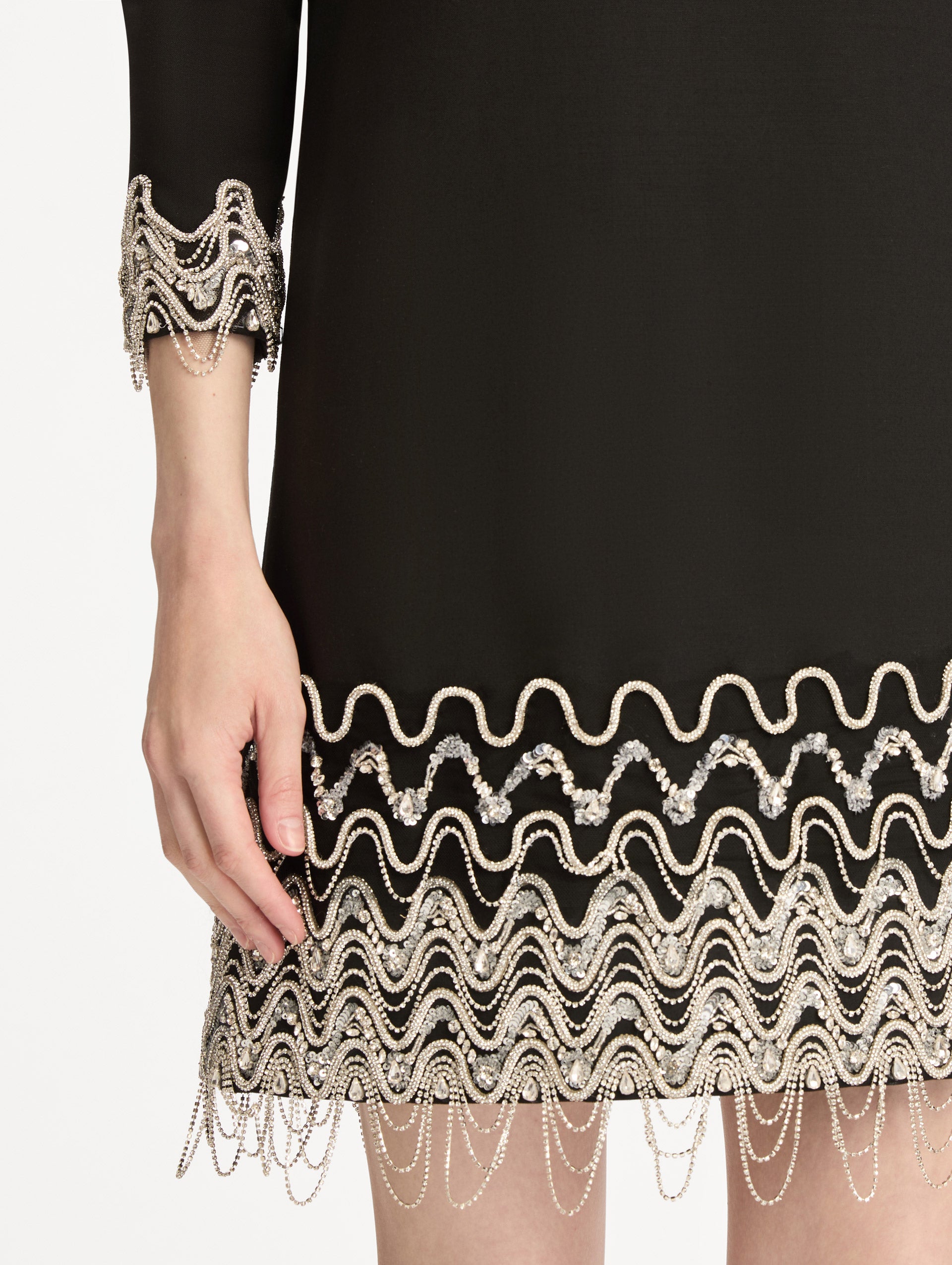 Black Crystal Wave Embroidered Shift Dress with long sleeves and beaded embellishments along the hemline and sleeve cuffs. Zoom View.