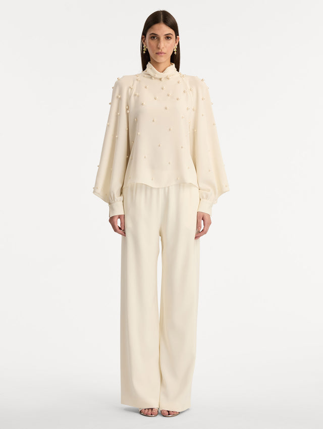 Ivory Pearl Cluster Georgette Blouse with long puff sleeves, a high neck, and pearl embellishments throughout. Front View.