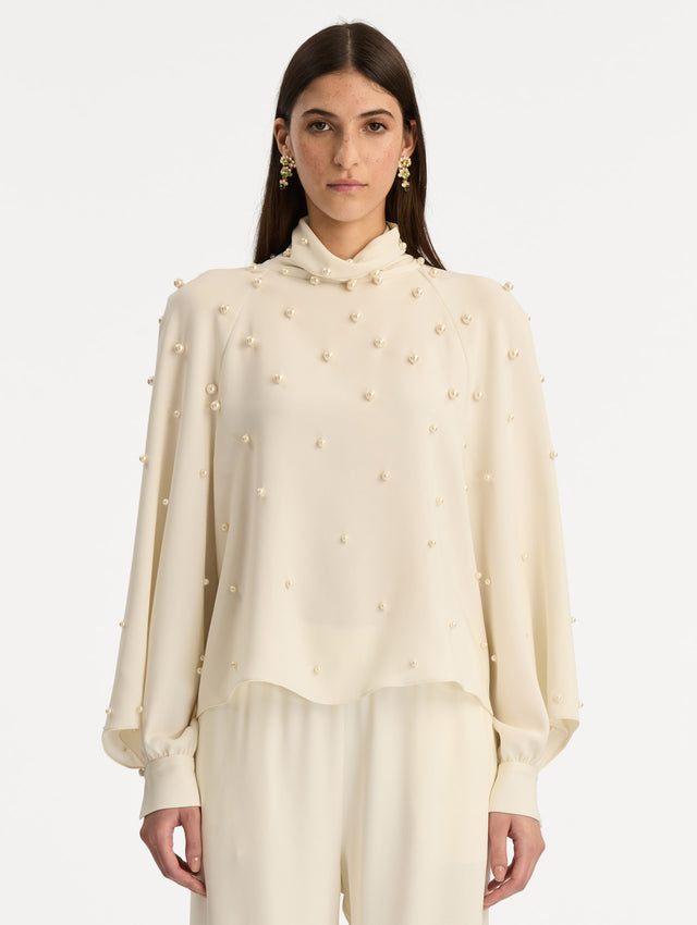Ivory Pearl Cluster Georgette Blouse with long puff sleeves, a high neck, and pearl embellishments throughout. Front View.
