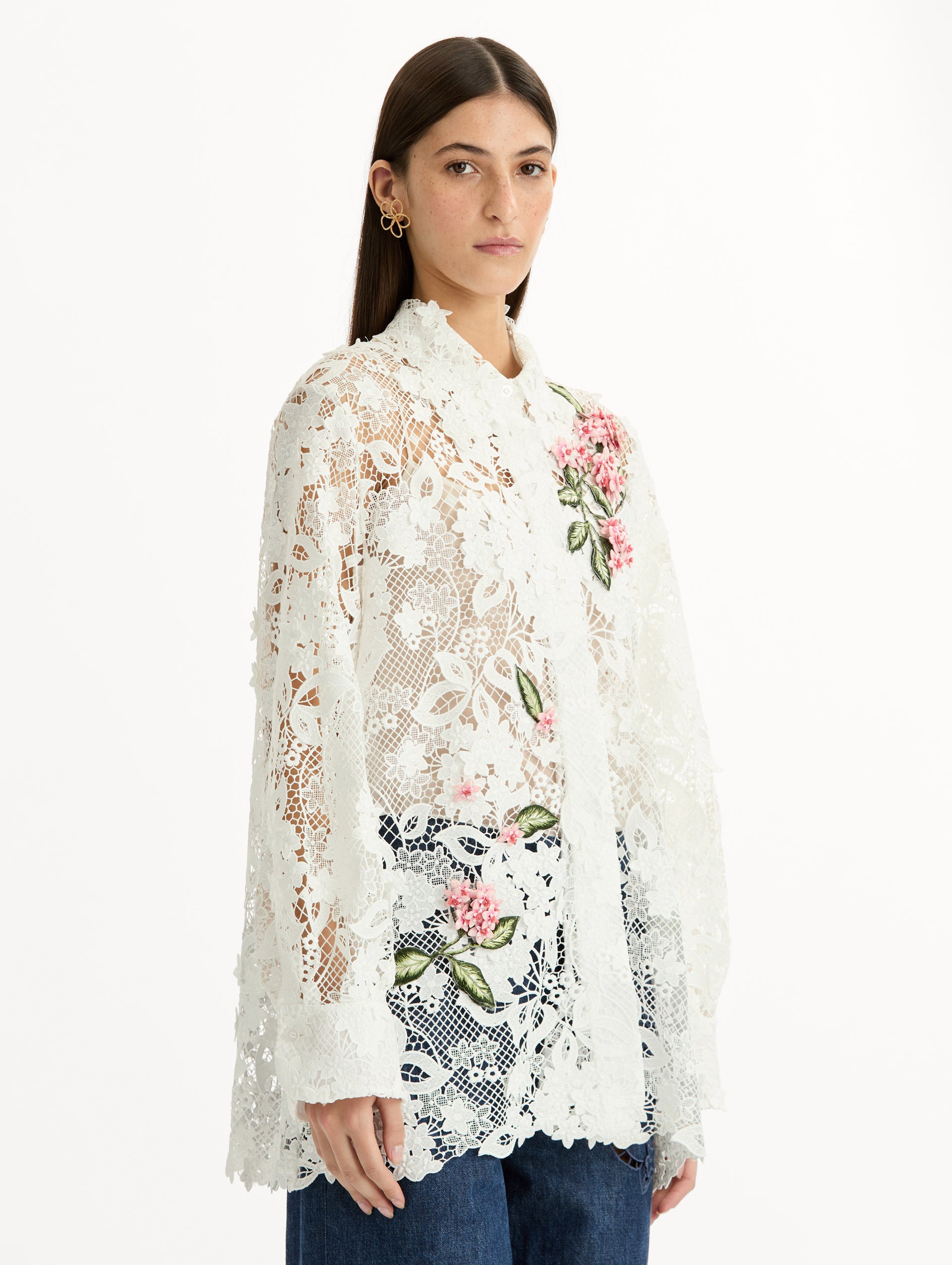 Long Sleeve, Button Up Blouse with Delicate guipure lace and intricate porcelain flower embroidery. White with pink florals. Side View.