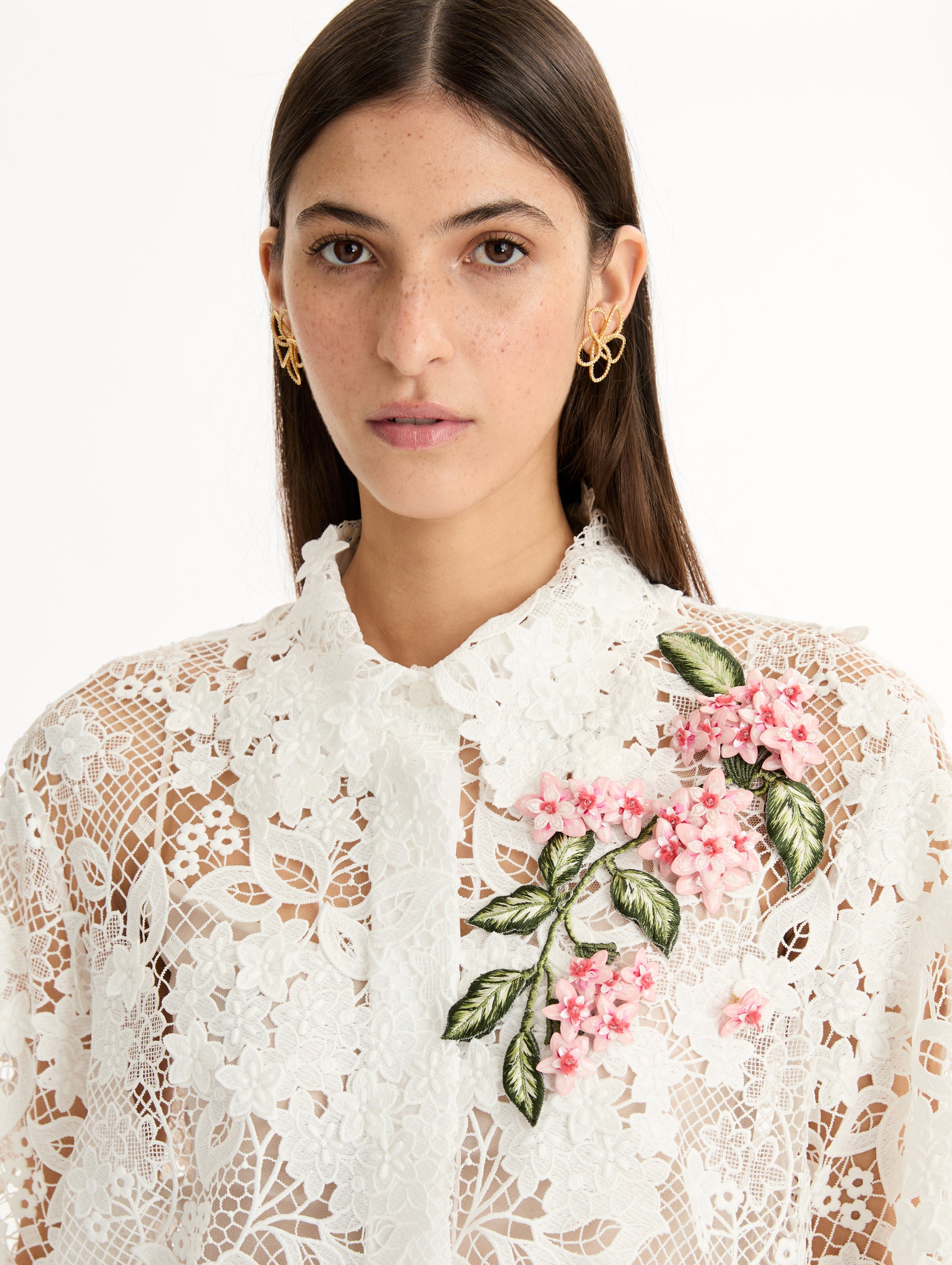 Long Sleeve, Button Up Blouse with Delicate guipure lace and intricate porcelain flower embroidery. White with pink florals. Front View, Up Close.