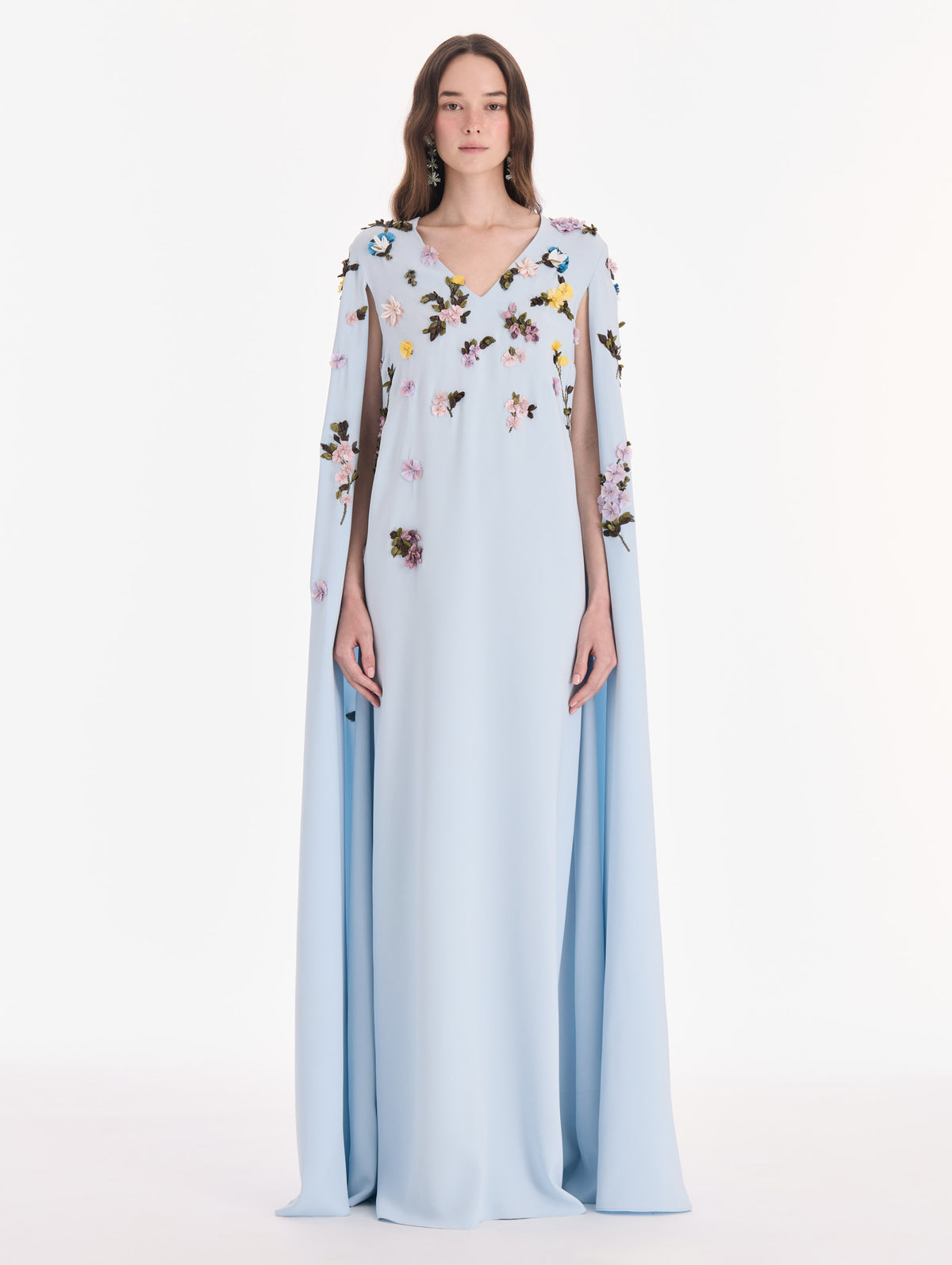 The model is wearing a draped sleeve mixed botanical on lace caftan. Front view.