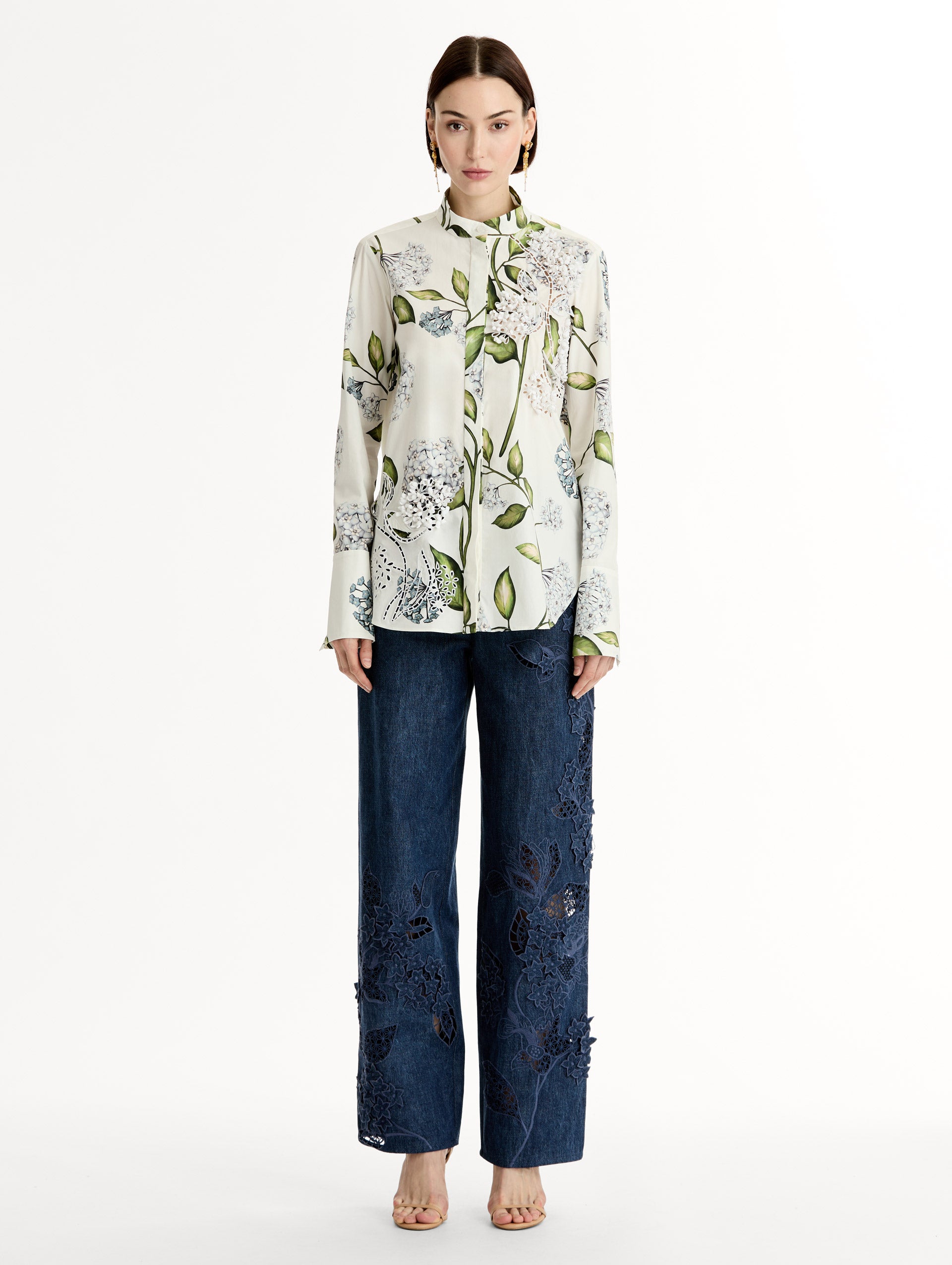 Porcelain flower print on cotton poplin blouse. Tailored silhouette and concealed button front. Threadwork cutout detailing. High Neckline. Front View.