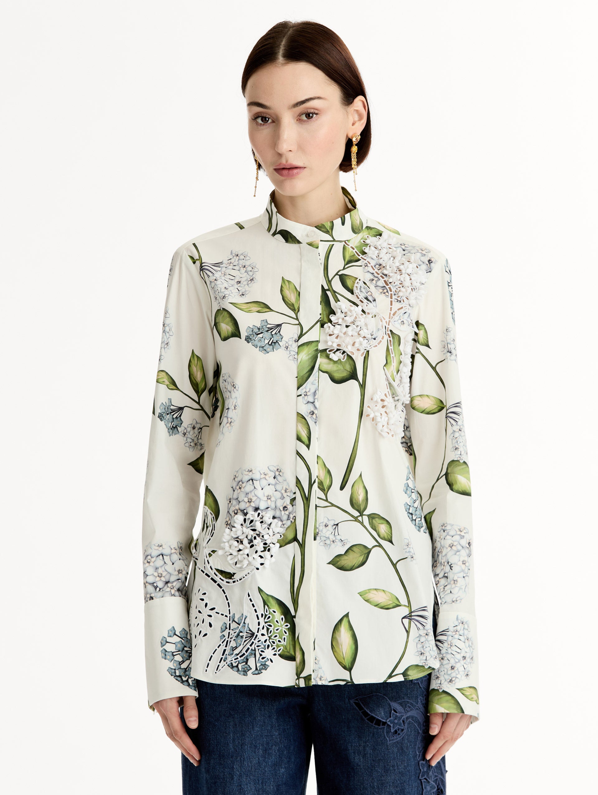 Porcelain flower print on cotton poplin blouse. Tailored silhouette and concealed button front. Threadwork cutout detailing. High Neckline. Front View.