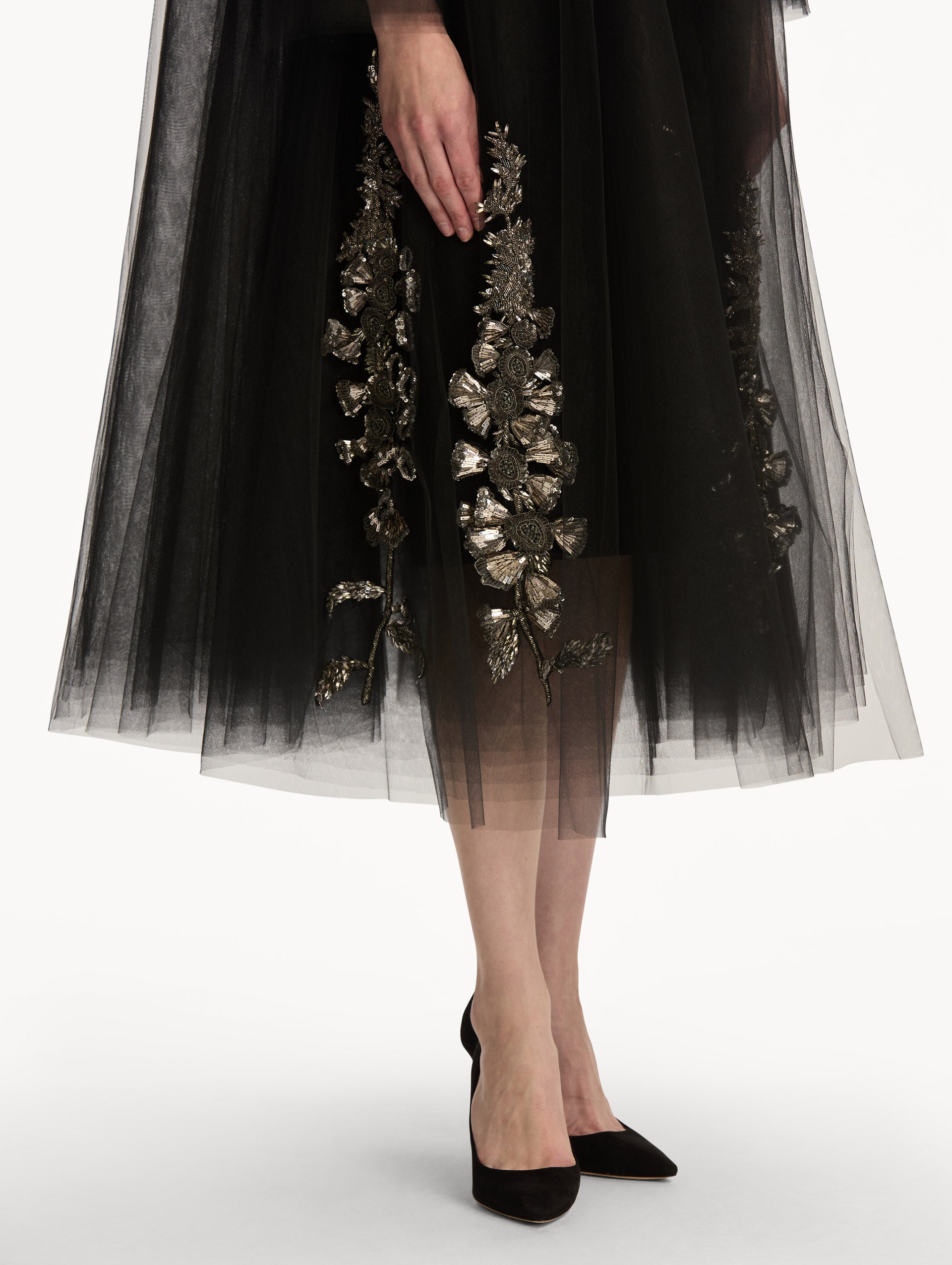 Black Foxglove Sequin Embroidered Opera Coat featuring a belted waist, wide collar, and embroidered floral detailing over a midi-length silhouette. Zoom View.