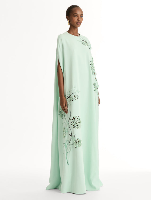 Mint caftan in heavy silk stretch georgette. Porcelain-flower threadwork cutouts.  Dimensional petals and delicately openwork stems. Side View. 