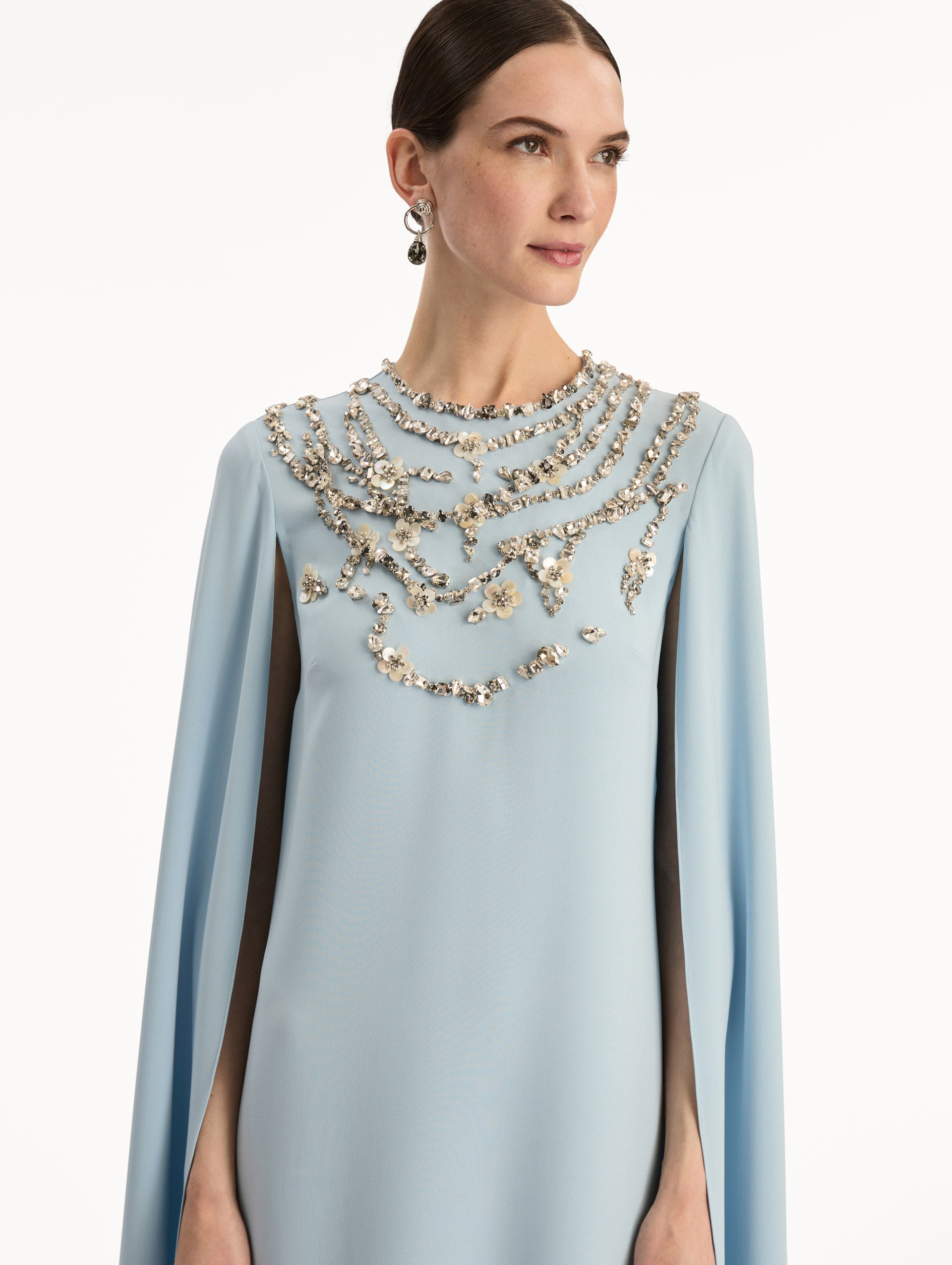 Light Blue Crystal Necklace Embroidered Caftan featuring a floor-length silhouette with draped sleeves and crystal embellishment along the neckline. Zoom View.