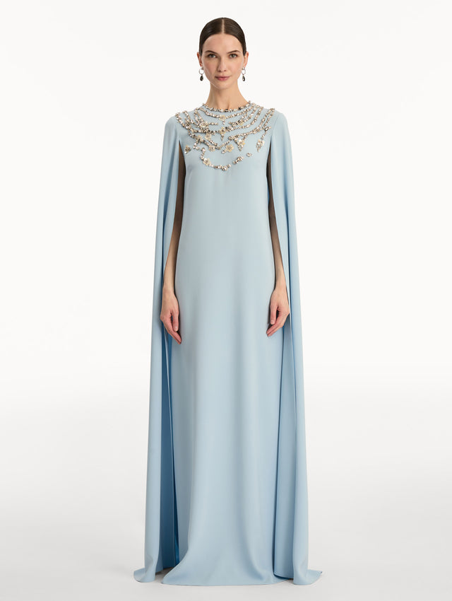 Light Blue Crystal Necklace Embroidered Caftan featuring a floor-length silhouette with draped sleeves and crystal embellishment along the neckline. Front View.
