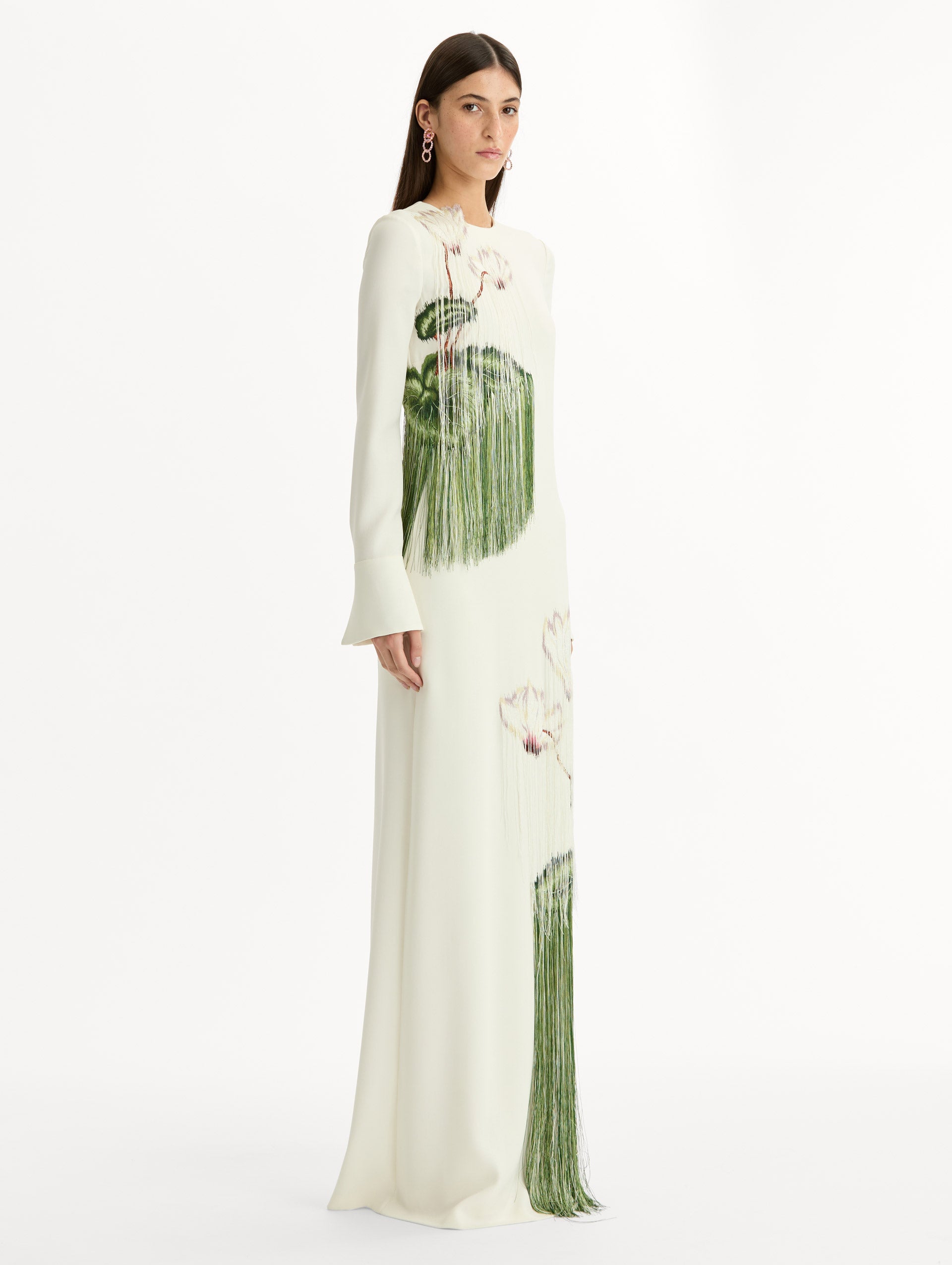 Ivory, long sleeve, floor length, heavy silk stretch georgette gown with Chiné Cyclamen motif in threadwork fringe. Side View.