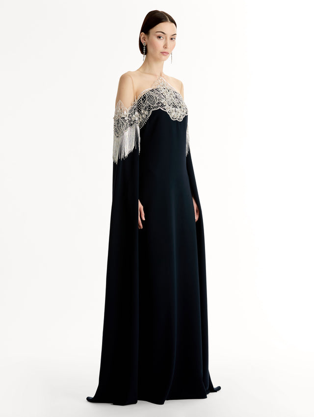 Caftan with sheer illusion tulle neckline and porcelain flower lattice. Hand-applied bugle beads around each motif, and fluid bugle bead fringe on sleeves. Side View. 