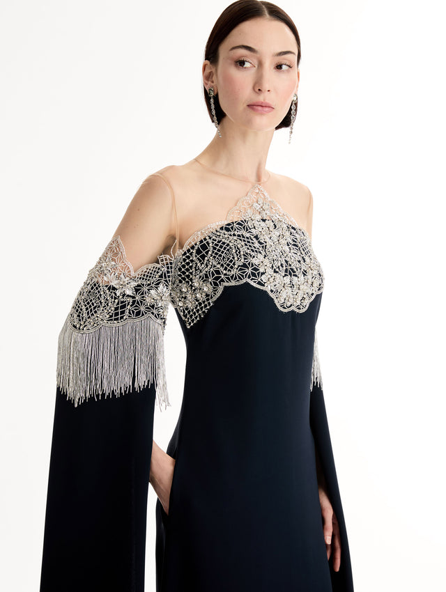 Caftan with sheer illusion tulle neckline and porcelain flower lattice. Hand-applied bugle beads around each motif, and fluid bugle bead fringe on sleeves. Close Up Side View. 