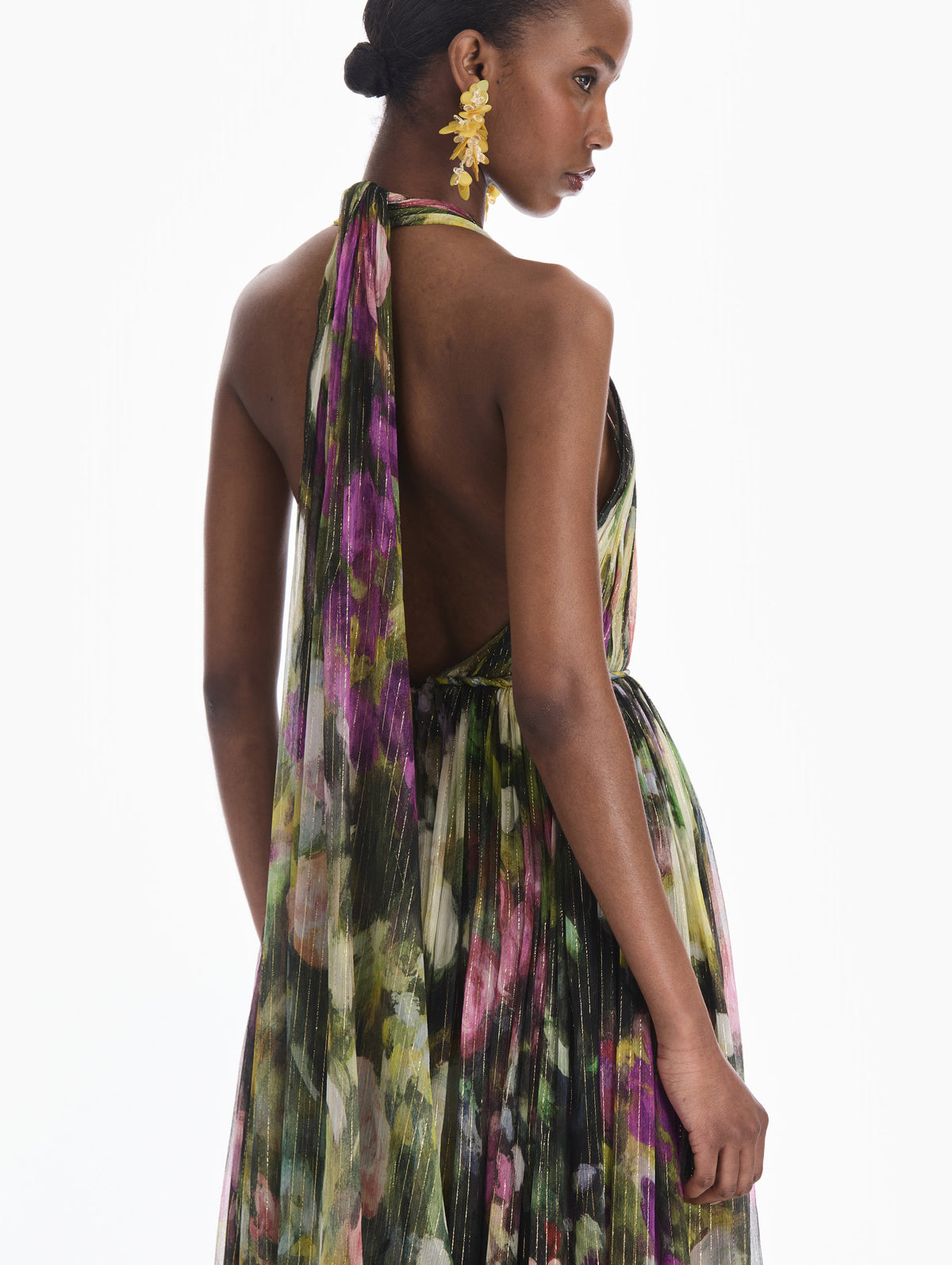 The model is wearing a sleeveless abstract landscape chiffon gown. Zoom view.
