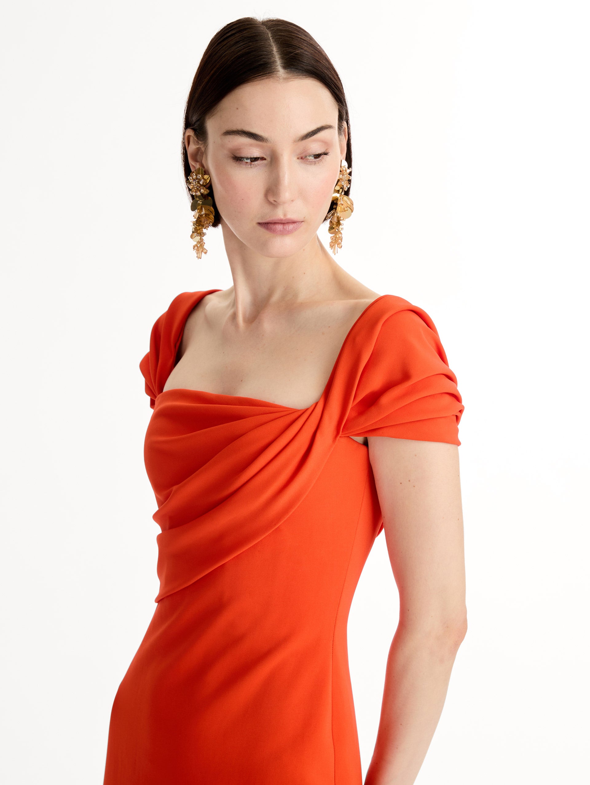 Fluid stretch cady gown with sculptural draping along neckline and shoulders. Short sleeve, column silhouette . Side View. 