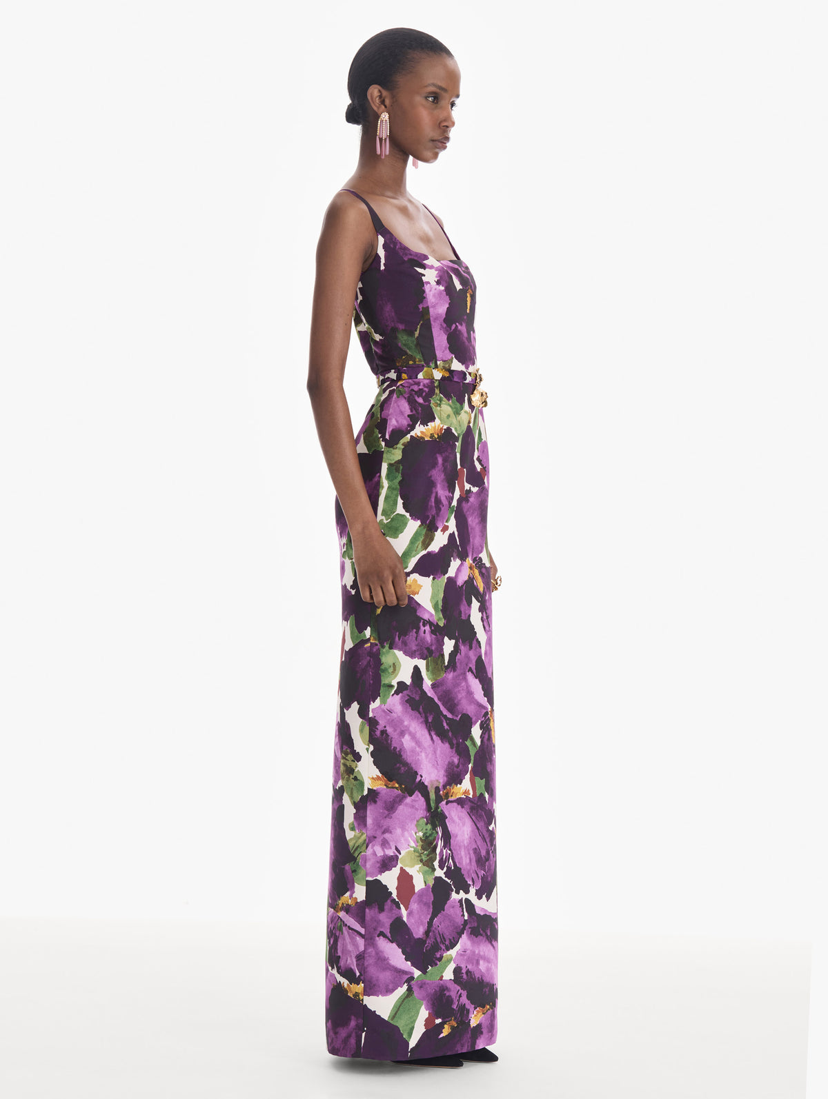 The model is wearing a sleeveless large watercolor iris faille gown. Side view.