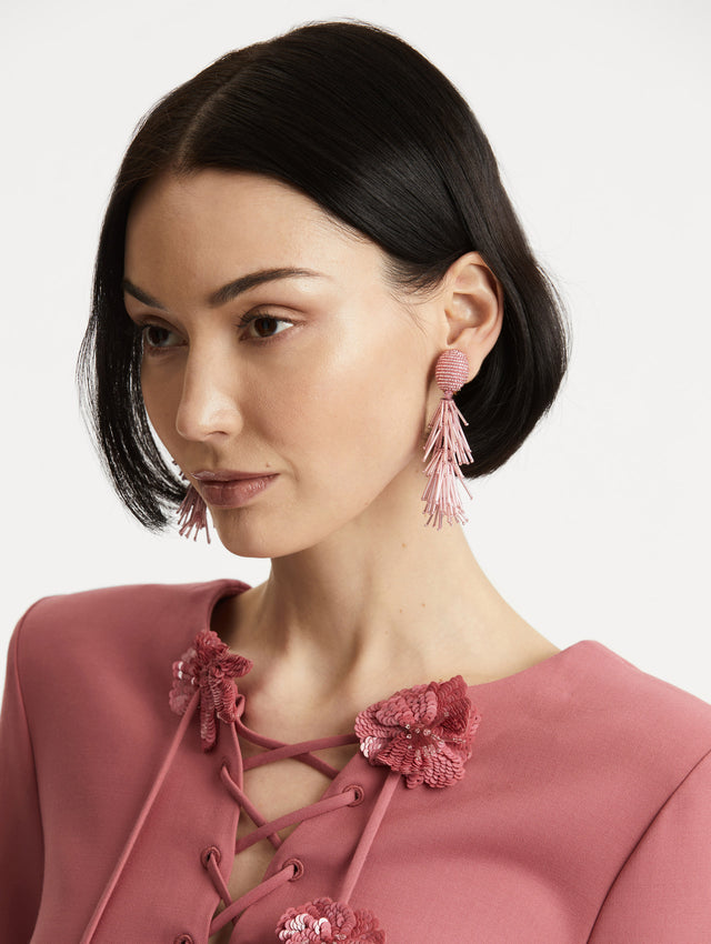 Model wearing tassel earrings in pink