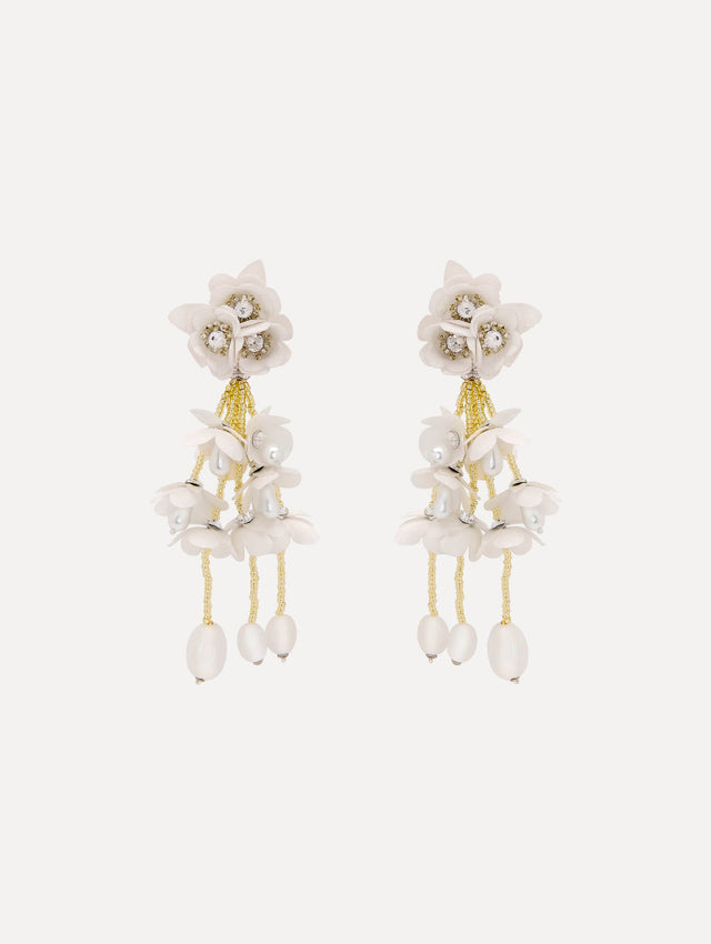 Tonal petals form a soft gradient in these floral drop earrings, accented with delicate beaded fringe. Finished with white drops.