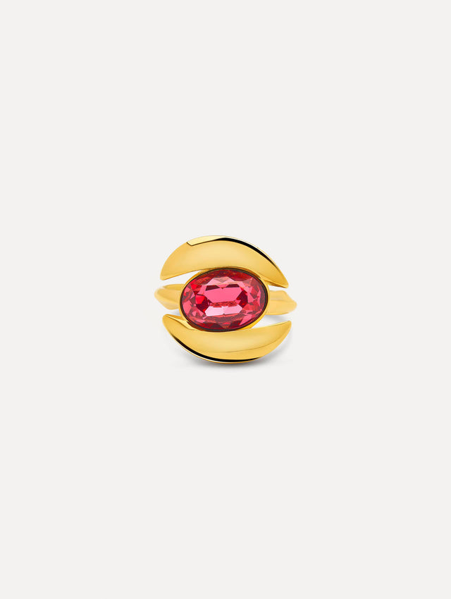 Ring frames a oval-cut stone in a curved setting. The polished gold-tone finish contrasts with the hue of the central gemstone. 