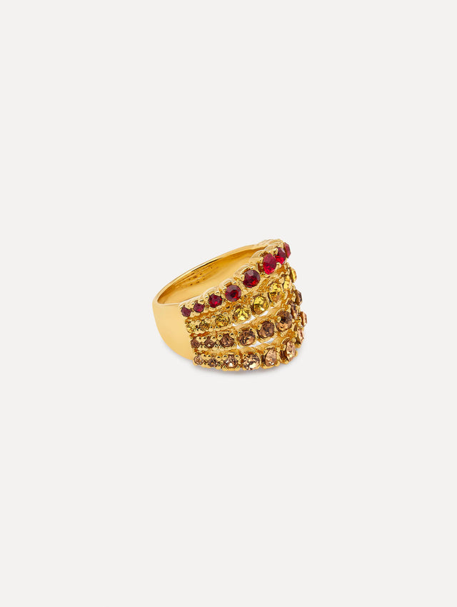 Side view of ring which features arched rows of faceted crystals set in a polished gold band with a layered design and sculptural curve.