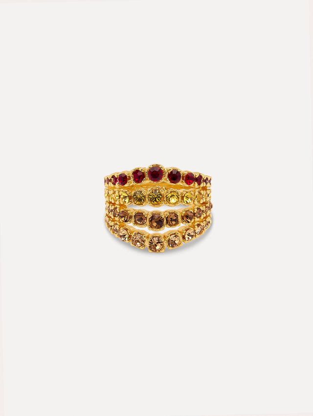 Ring features arched rows of faceted crystals set in a polished gold band with a layered design and sculptural curve.