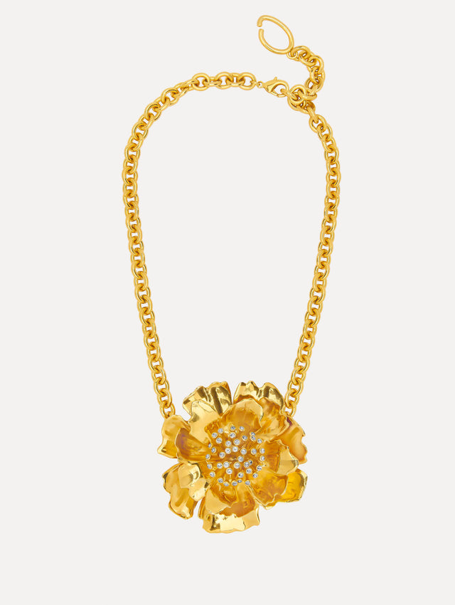 Chain-link necklace features an peony pendant suspended at its center, cast in a gold finish with sculptural petals. A cluster of pavé crystals forms the middle of the bloom.