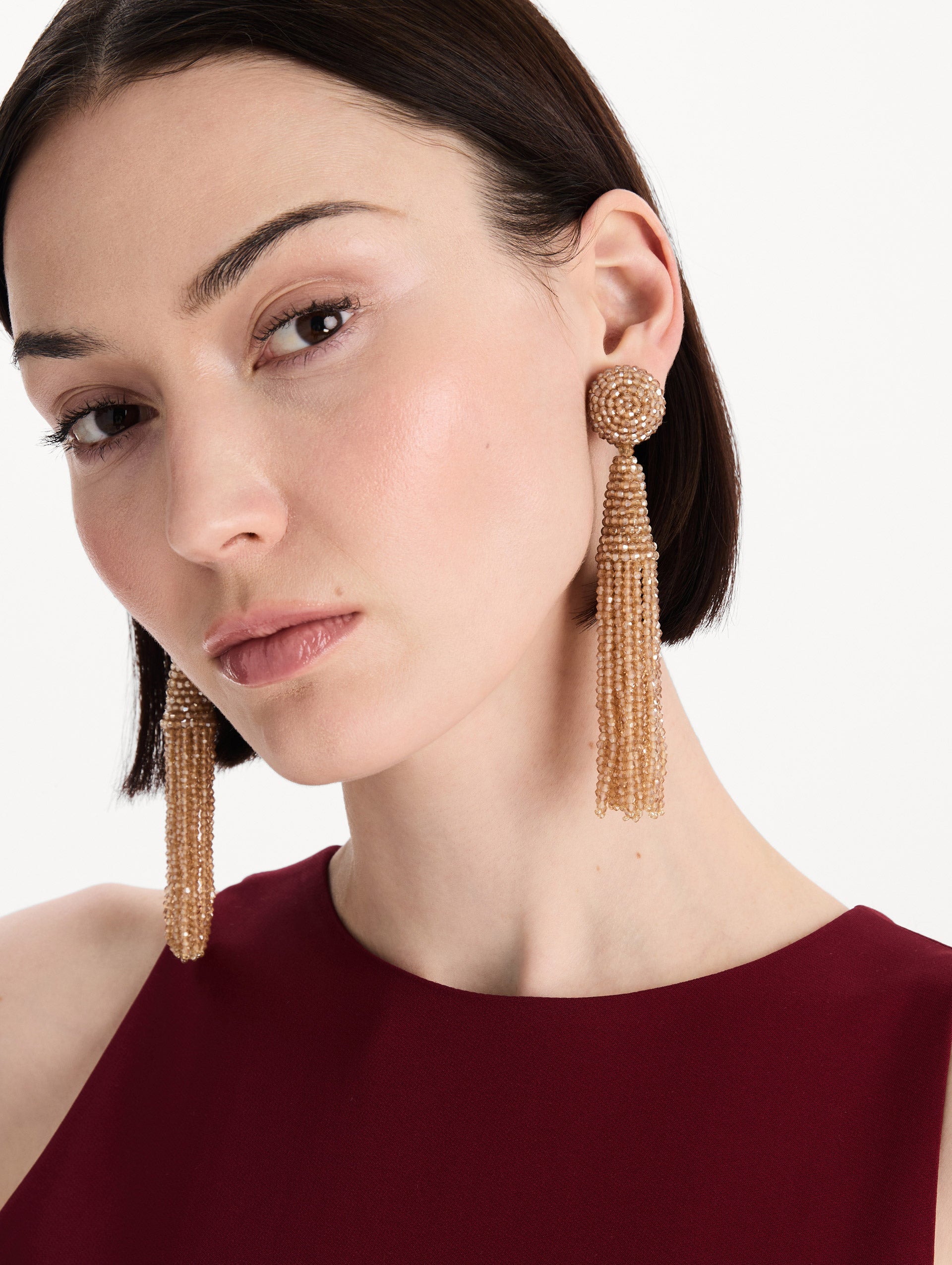The Conical Tassel Clip-On Earrings in Champagne. Front view.