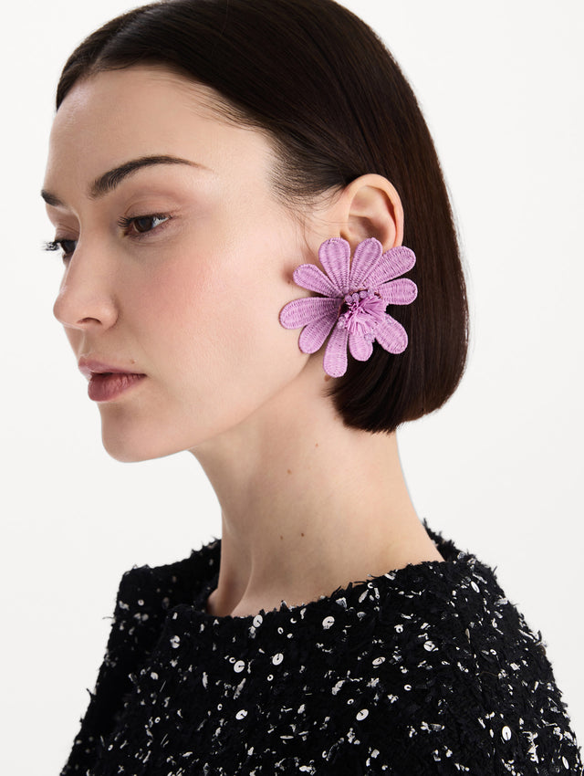 The Woven Raffia Flower Clip-On Earrings in Lilac. Front view.