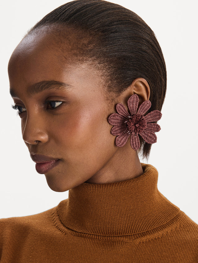 The Woven Raffia Flower Clip-On Earrings in Mauve. Front view.