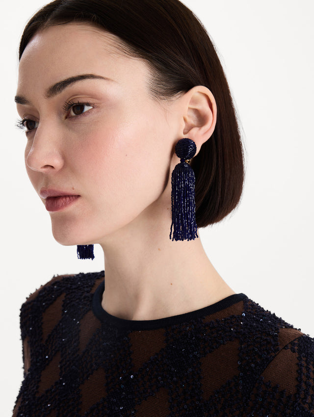 The Metallic Beaded Tassel Clip-On Earrings in Navy. Front view.
