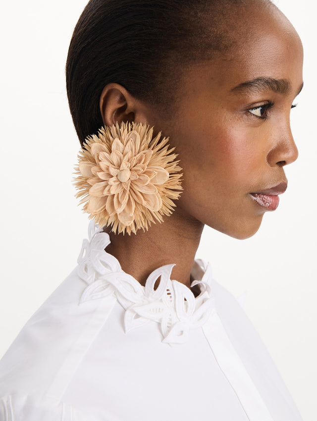 The Raffia Flower Clip-On Earrings in Natural. Front view.