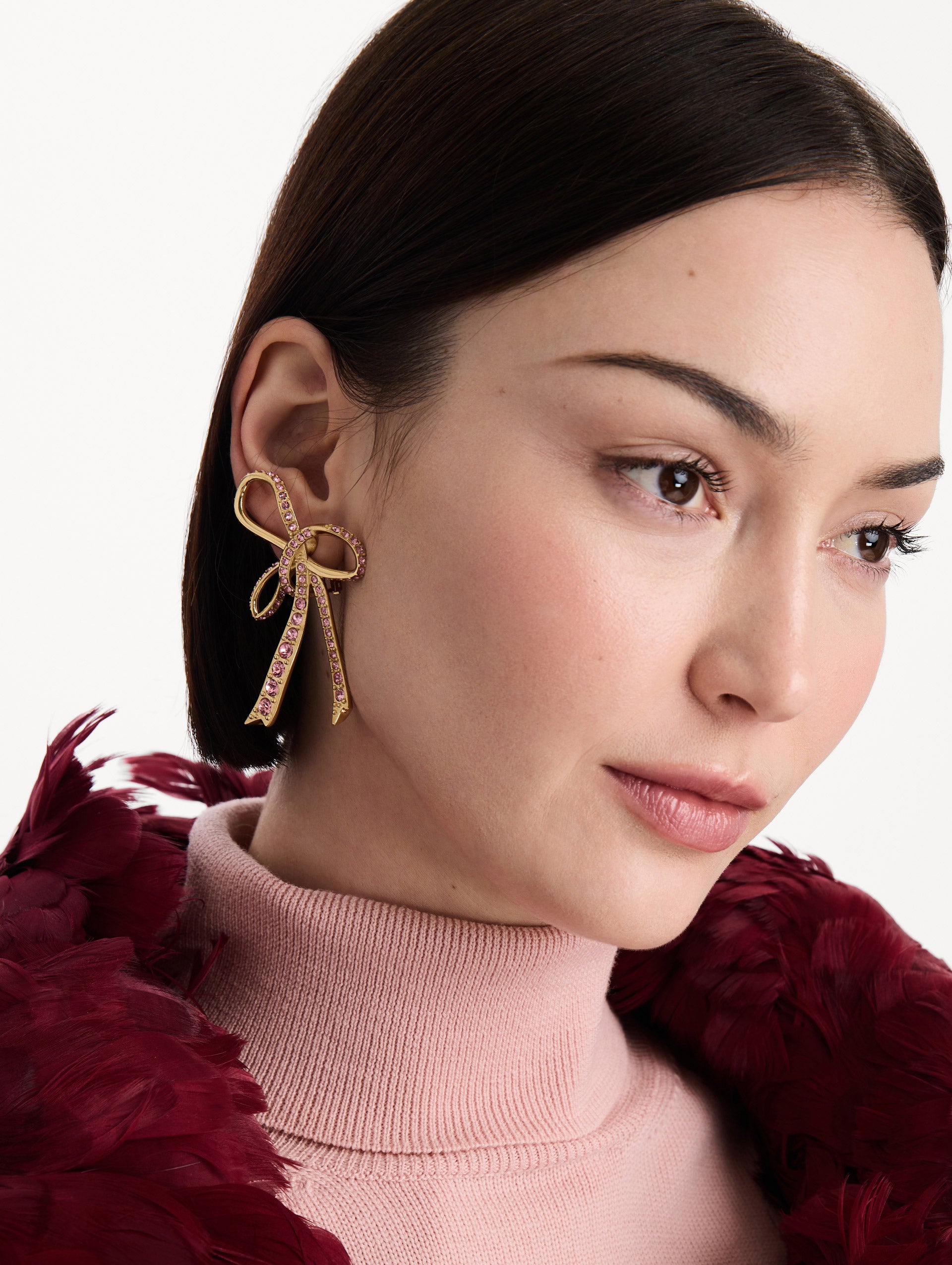 The Crystal Pavé Threaded Bow Clip-On Earrings in Rose. Front view.
