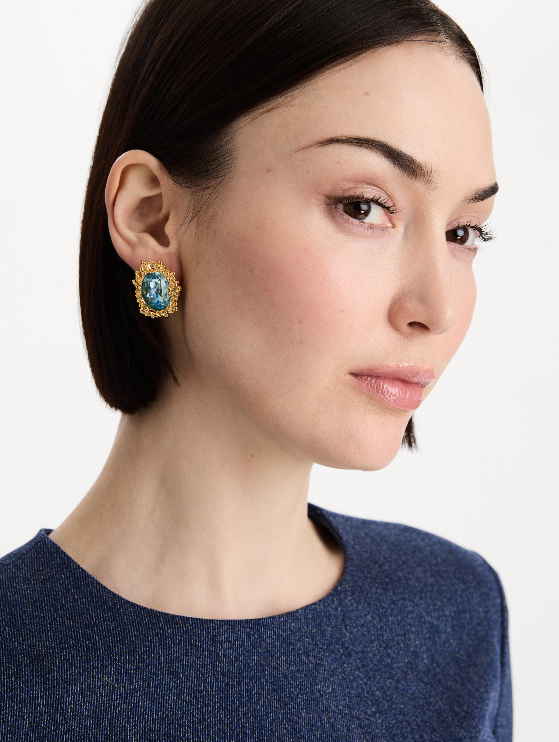The Oval Medallion Clip-On Earrings in Aqua. Front view.