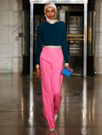 A model wears pink pants and a navy top