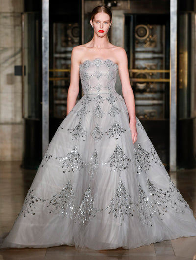 A model wears a silver gown with stars