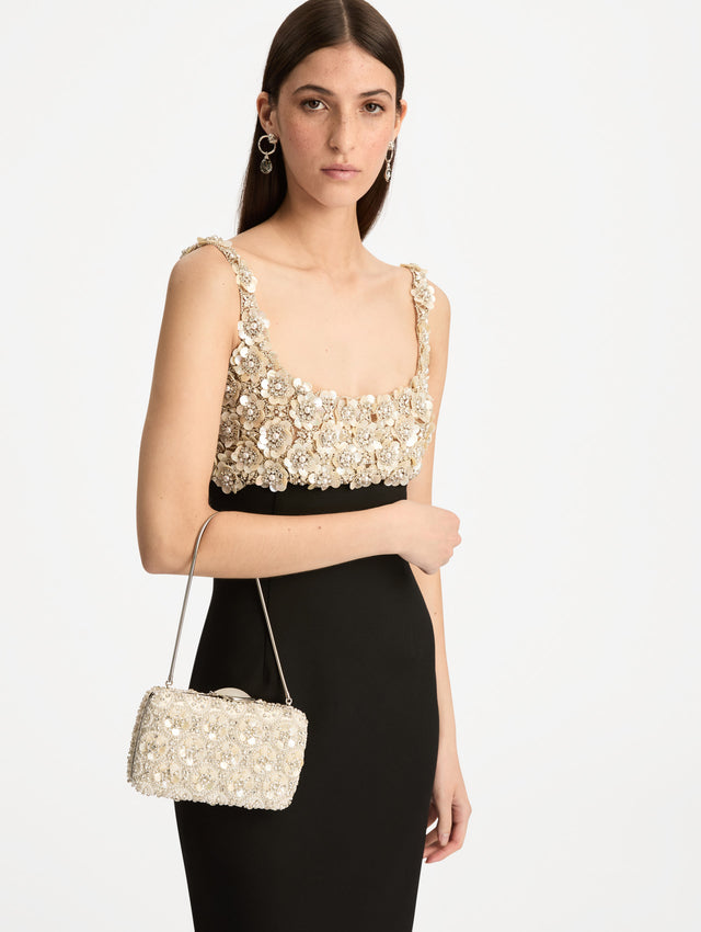 Ivory Mother of Pearl Embroidered O Minaudière featuring ivory beaded flowers, crystal detailing, and a structured rectangular silhouette with top clasp closure. Front View.