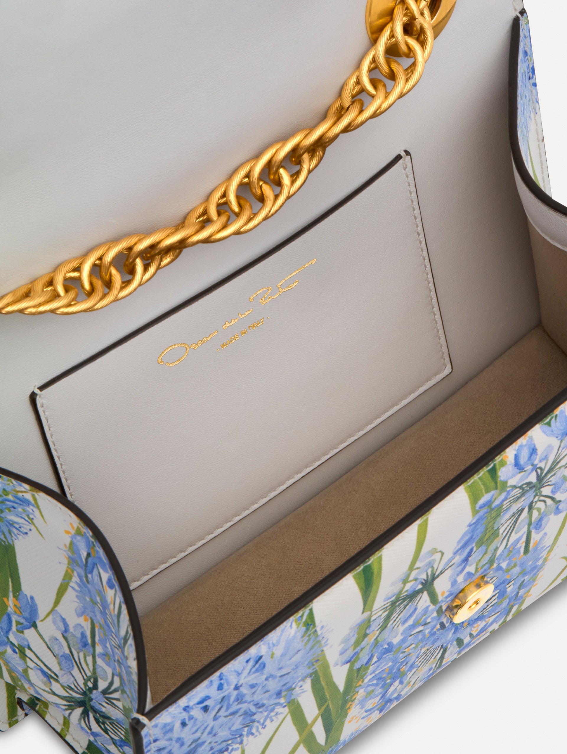 White, blue and green Allium Printed TRO Bag with gold hardware and flower embellishment. Zoom View.