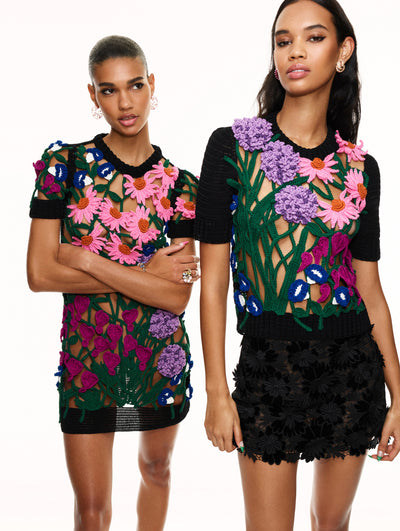 Two models pose against a white backdrop in Oscar de la Renta floral crochet ready-to-wear styles. 