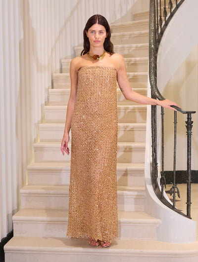The model wears a strapless crystal embroidered gown.  