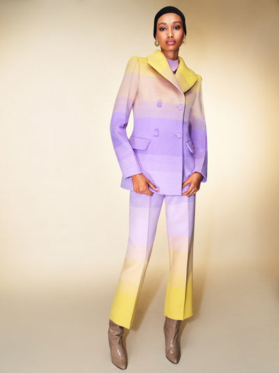 The model is wearing a matching ombre pantsuit, ranging from yellow to lilac. 