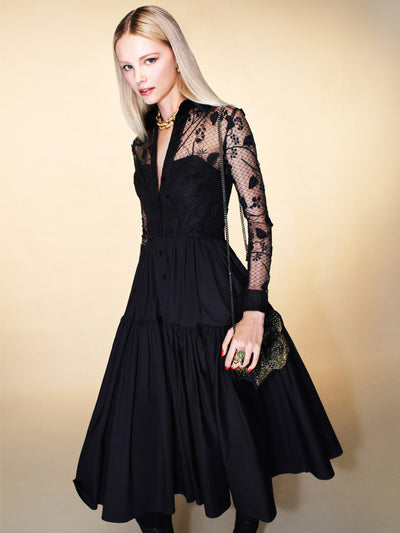 The model is wearing a black midi dress with lace sleeves. 